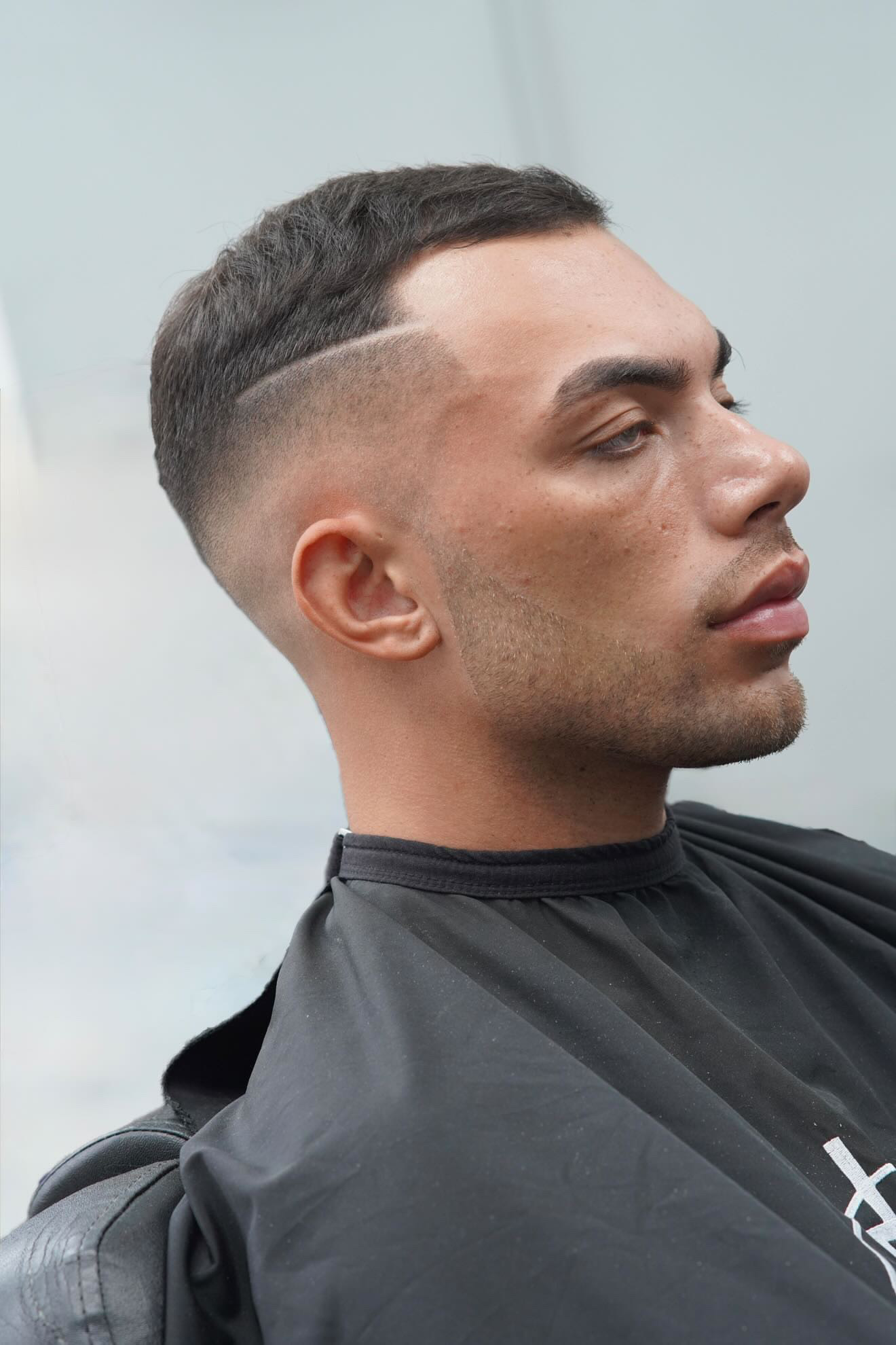 Skin fade with hard part design at PB Barbers