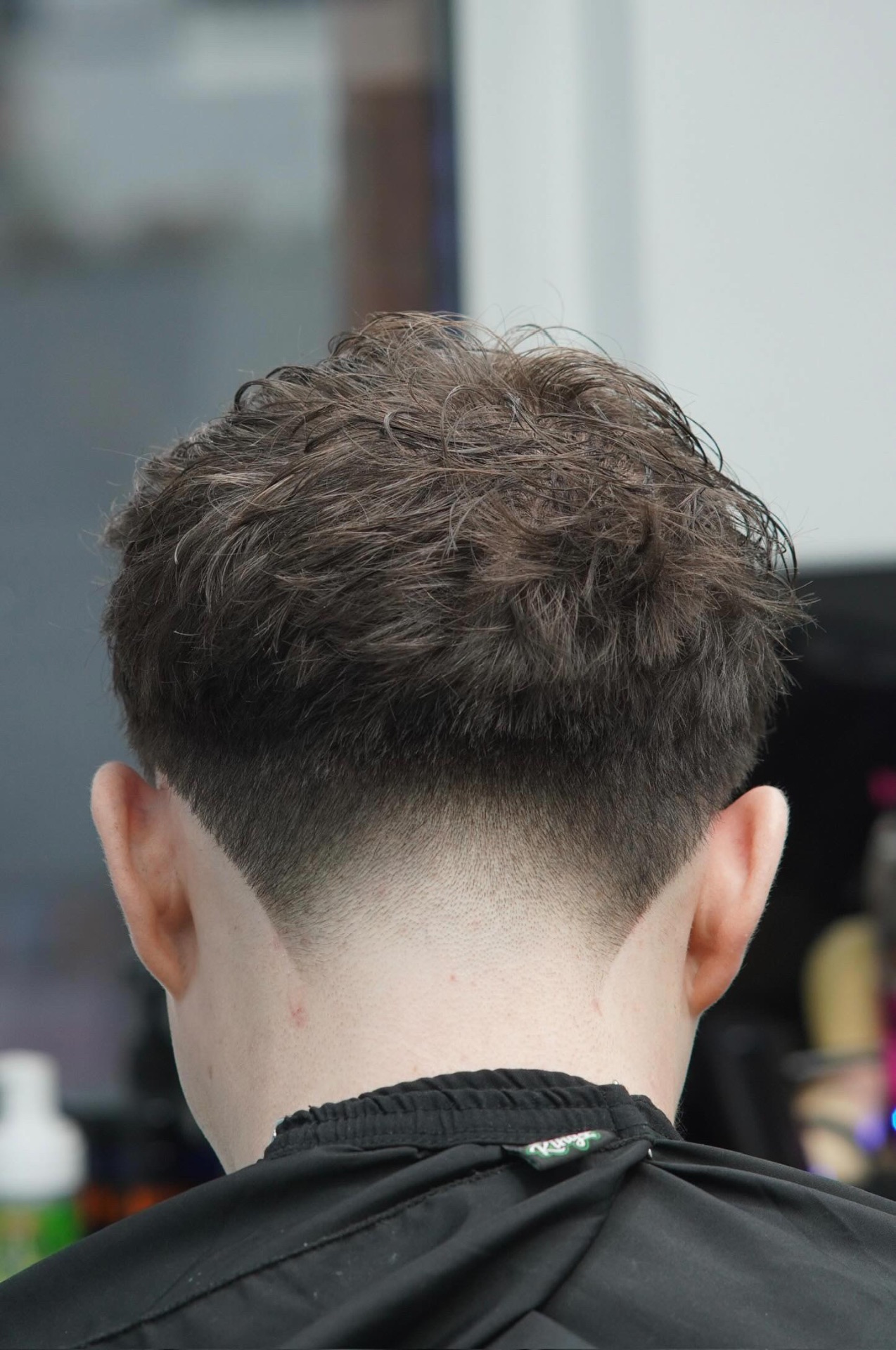 Textured crop with low taper at PB Barbers