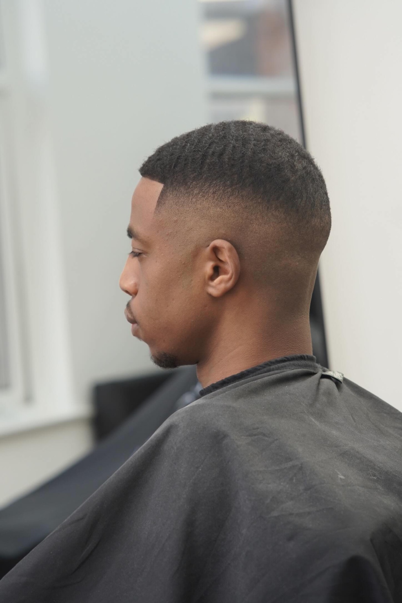 Waves with high skin fade at PB Barbers