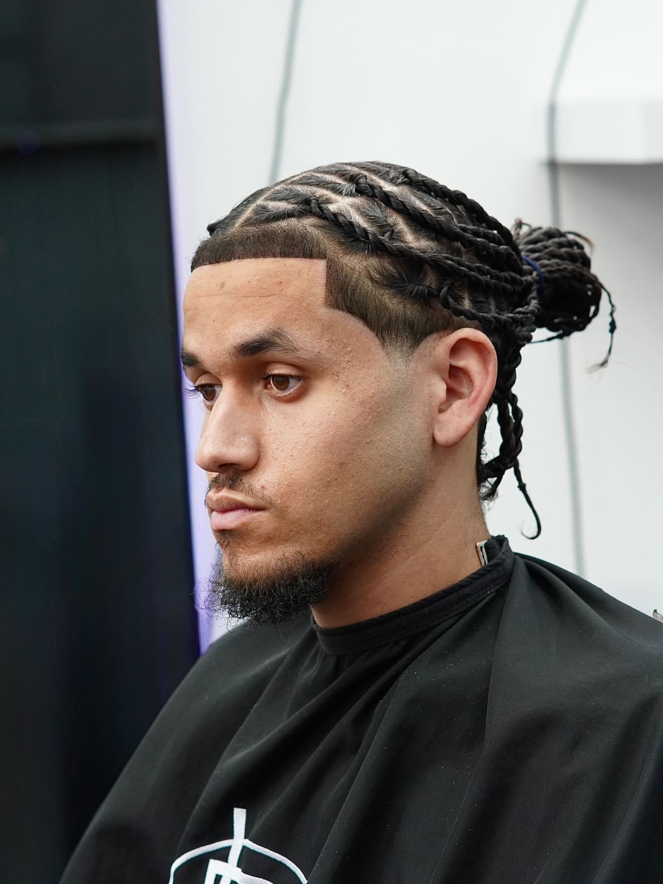 Braids with man bun and taper fade at PB Barbers